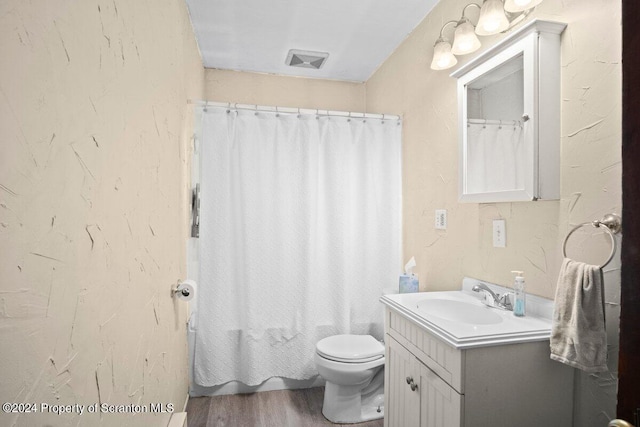 bathroom featuring hardwood / wood-style floors, vanity, and toilet