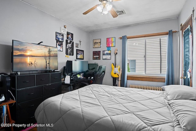 bedroom featuring ceiling fan and radiator heating unit