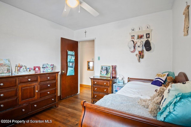 bedroom featuring ceiling fan and dark wood-type flooring