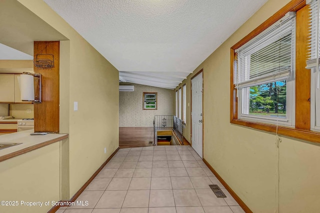 331 Drake St, Old Forge, PA 18518 - hallway featuring an AC wall unit, lofted ceiling, a textured ceiling, light tile patterned floors, and baseboards