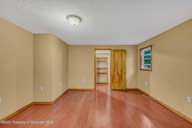 331 Drake St, Old Forge, PA 18518 - spare room featuring light wood-style floors, a textured ceiling, and baseboards
