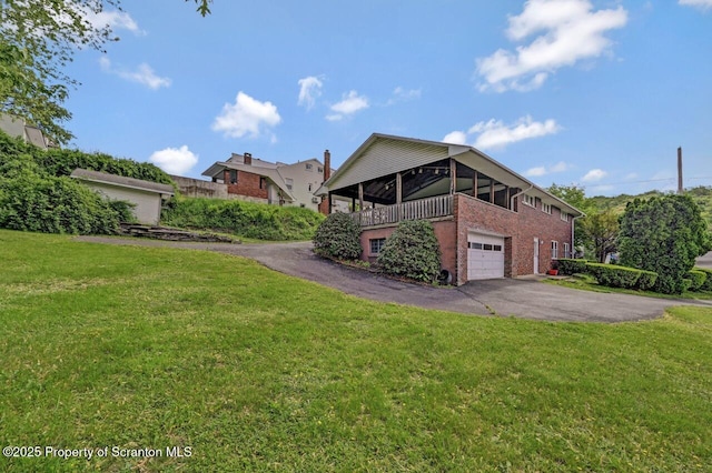 1130 Stafford Ave, Scranton, PA 18504 - view of side of home featuring brick siding, asphalt driveway, and a yard