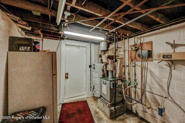 1130 Stafford Ave, Scranton, PA 18504 - unfinished below grade area featuring freestanding refrigerator, a heating unit, and gas water heater