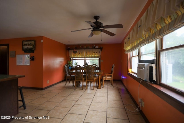 dining area featuring light tile patterned flooring, a healthy amount of sunlight, baseboards, and ceiling fan