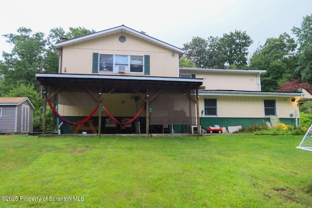 back of property featuring a lawn, a storage shed, and an outdoor structure