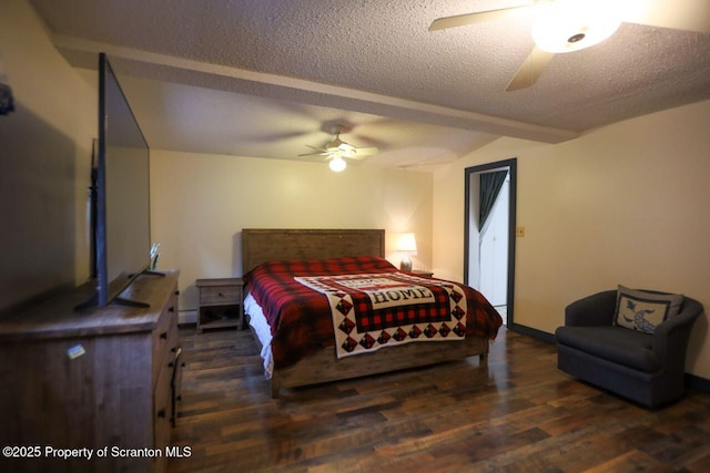 bedroom with ceiling fan, wood finished floors, baseboard heating, and a textured ceiling