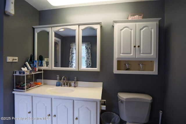 bathroom with toilet and vanity