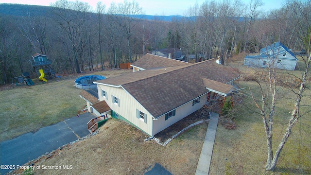 drone / aerial view featuring a view of trees