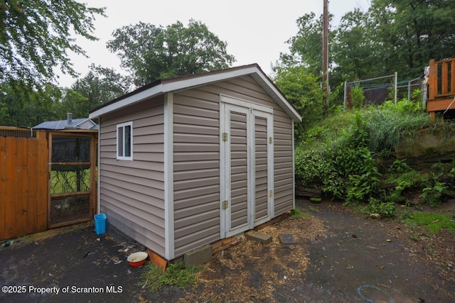 view of shed with fence