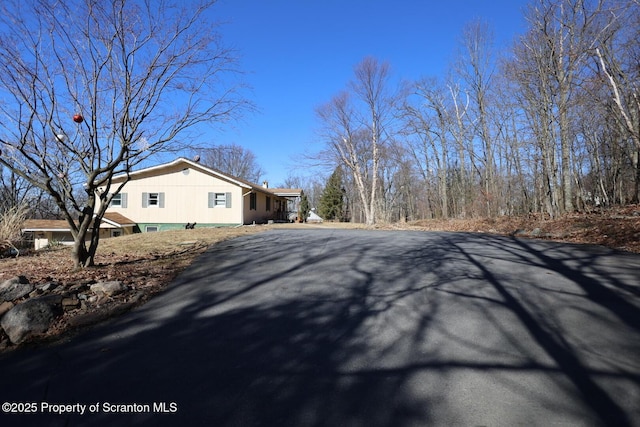 view of side of home featuring driveway