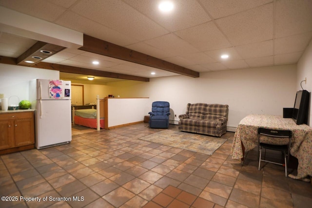 interior space with beam ceiling, baseboard heating, recessed lighting, and a drop ceiling