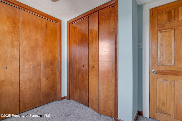 interior space with light carpet and a textured ceiling