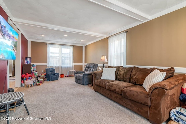 living room with ornamental molding, beam ceiling, and carpet floors