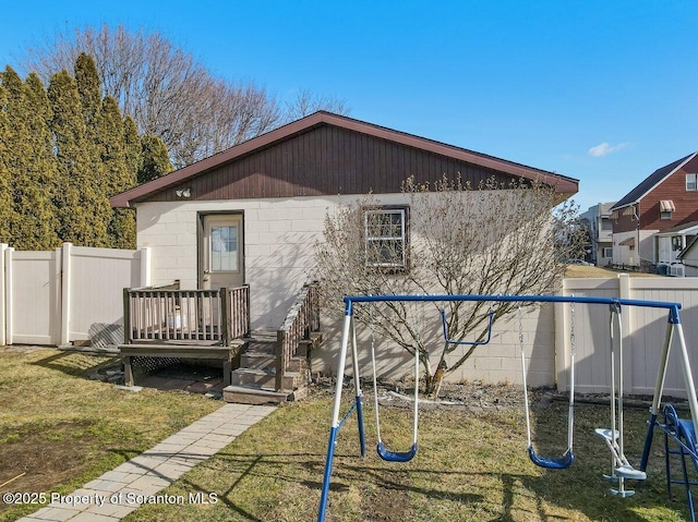 exterior space with a wooden deck and a lawn