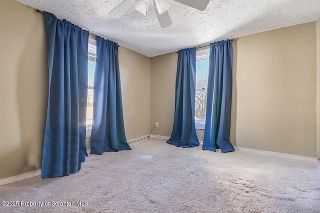 carpeted spare room with ceiling fan and a textured ceiling