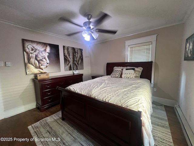 bedroom with crown molding, a ceiling fan, baseboards, dark wood-style floors, and a baseboard radiator