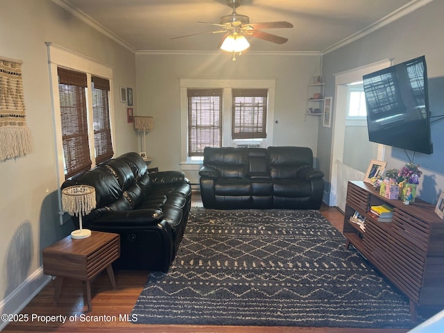 living area with crown molding, baseboards, ceiling fan, and wood finished floors