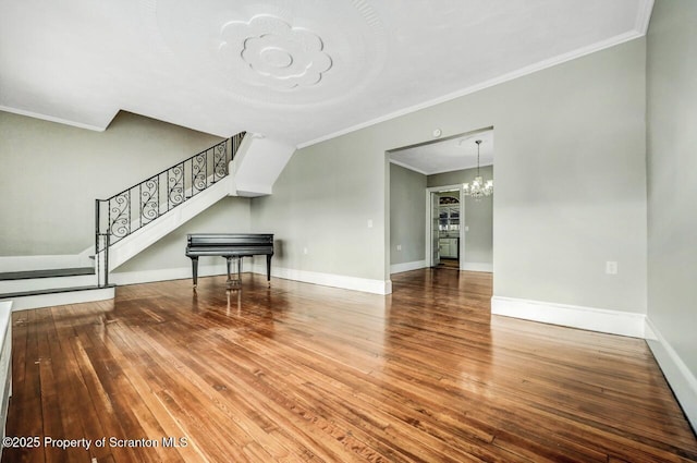 unfurnished living room featuring crown molding and hardwood / wood-style floors