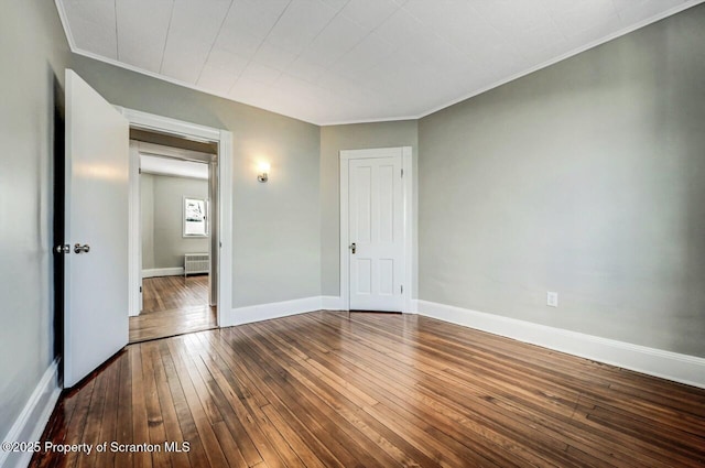 unfurnished bedroom featuring hardwood / wood-style floors and ornamental molding