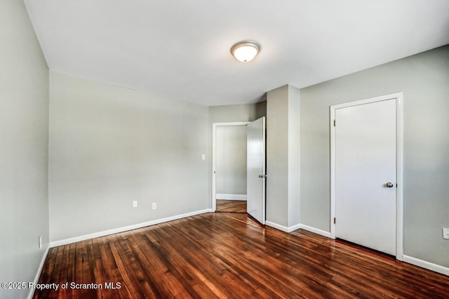 unfurnished bedroom with dark hardwood / wood-style floors