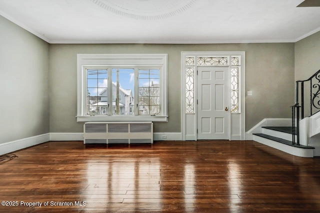 entrance foyer with ornamental molding, dark hardwood / wood-style floors, and radiator