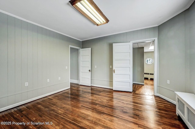 unfurnished bedroom with ornamental molding and dark wood-type flooring