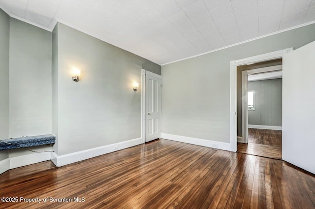 unfurnished room with wood-type flooring and crown molding