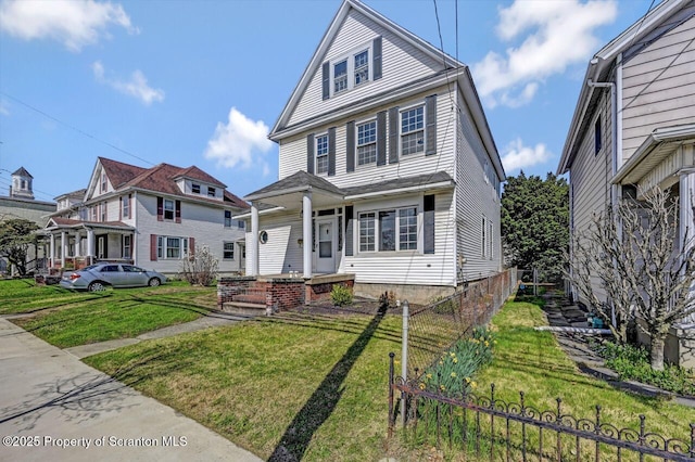 view of front of house with a front lawn and fence