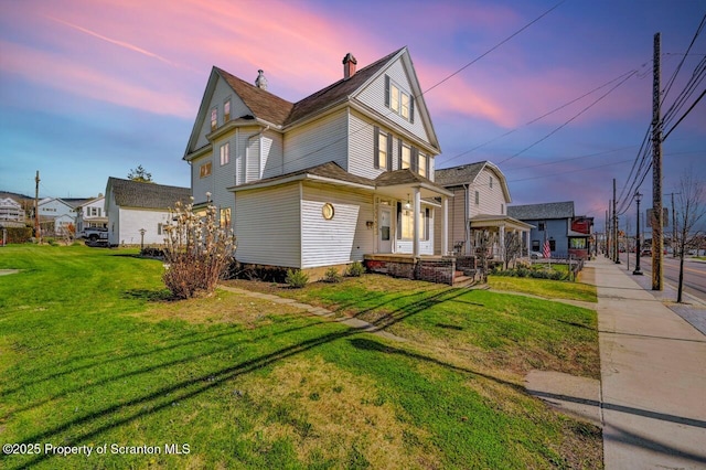 view of front of house with a porch and a front yard