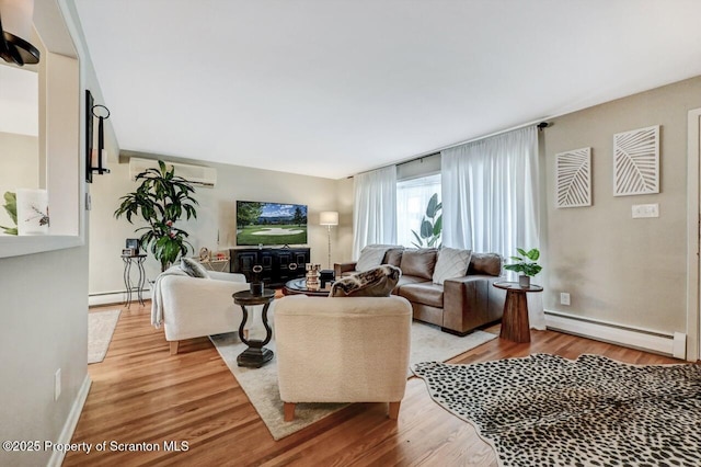 living room featuring light wood-style flooring and a baseboard radiator