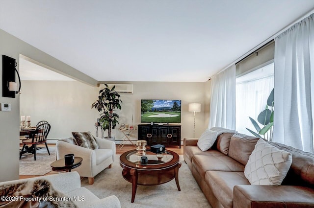 living area with a baseboard heating unit and an AC wall unit