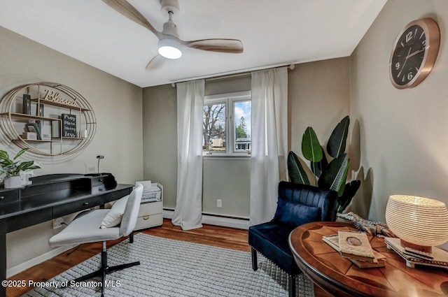 office with wood finished floors, a baseboard heating unit, ceiling fan, and a baseboard radiator
