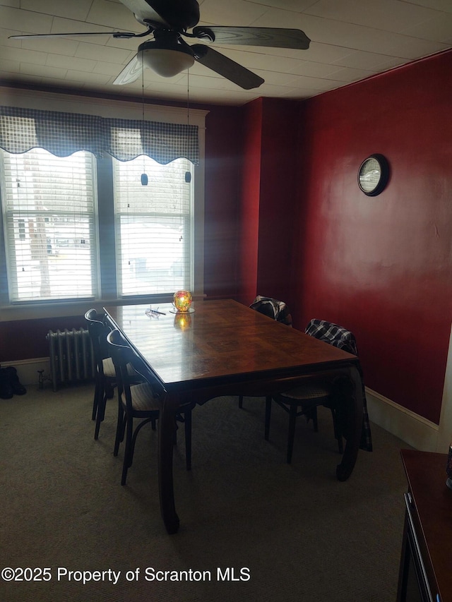 dining room featuring radiator heating unit, ceiling fan, and carpet flooring