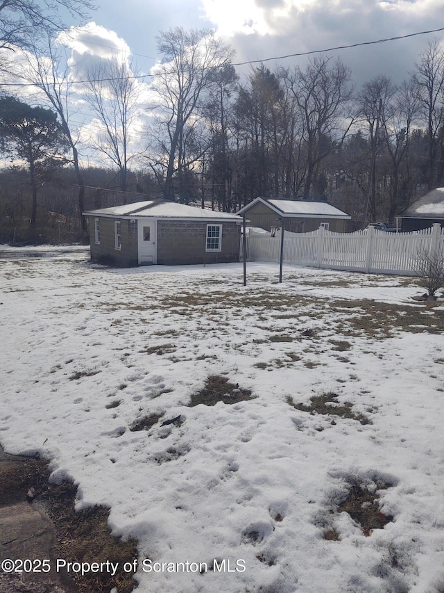 snowy yard featuring a carport