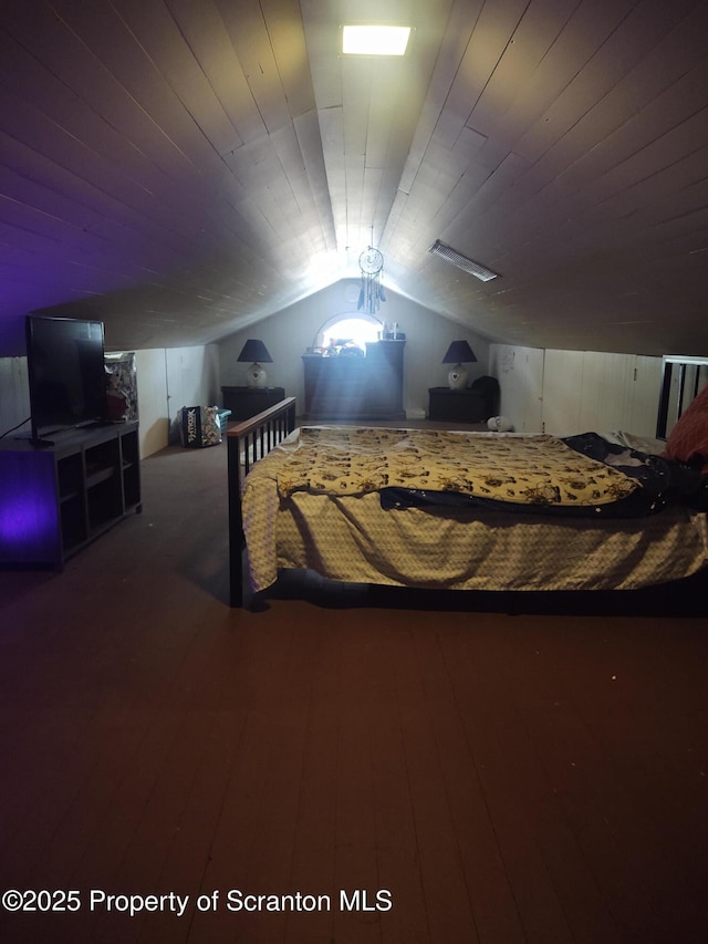 bedroom featuring hardwood / wood-style flooring, vaulted ceiling, and wooden ceiling