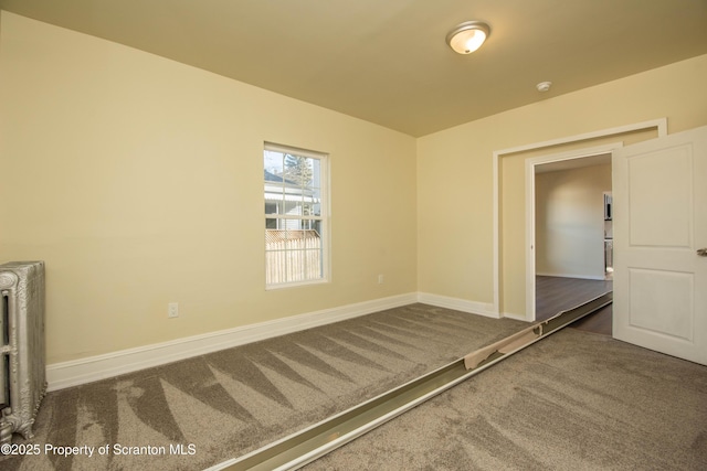 unfurnished room featuring carpet and baseboards