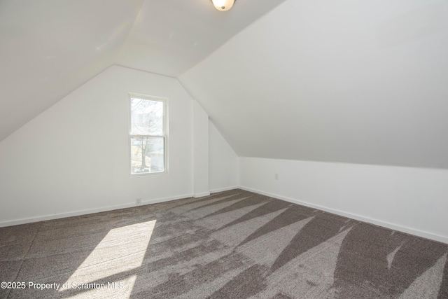 bonus room featuring carpet, vaulted ceiling, and baseboards