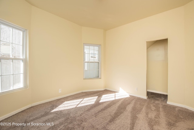 carpeted empty room with baseboards