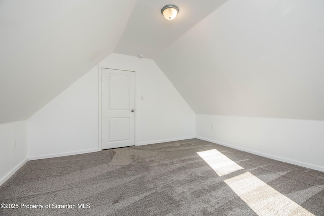 bonus room with lofted ceiling, carpet floors, and baseboards