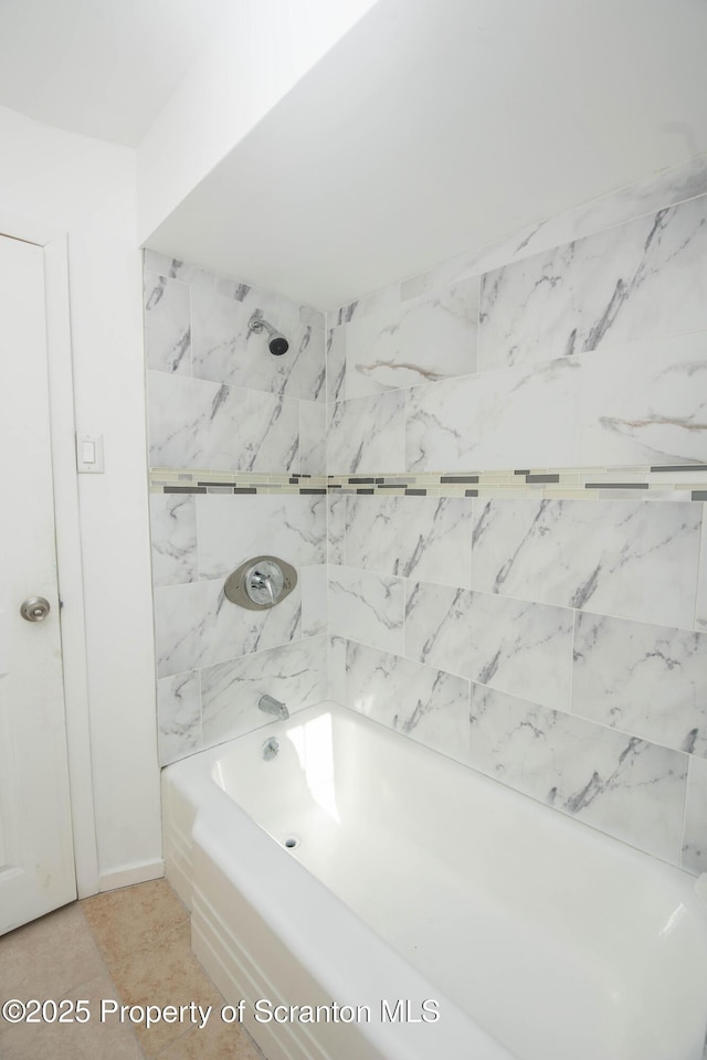 bathroom featuring tile patterned flooring and bathtub / shower combination