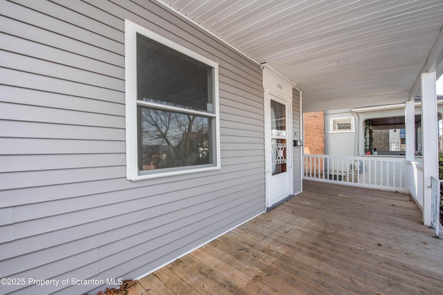 wooden terrace with a porch