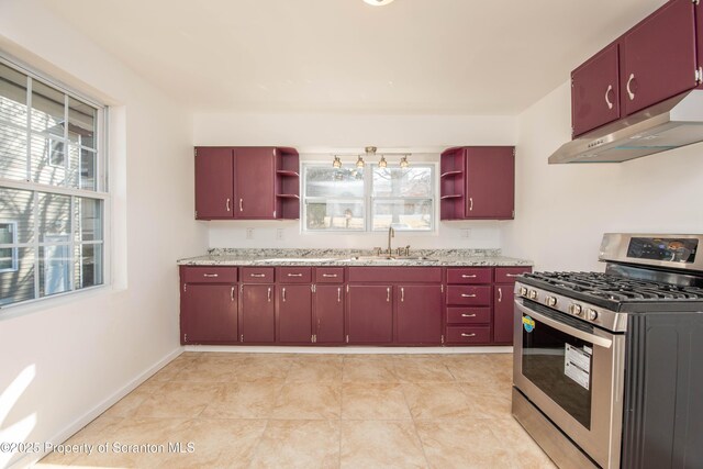 kitchen featuring red cabinets, open shelves, a sink, under cabinet range hood, and stainless steel gas range oven