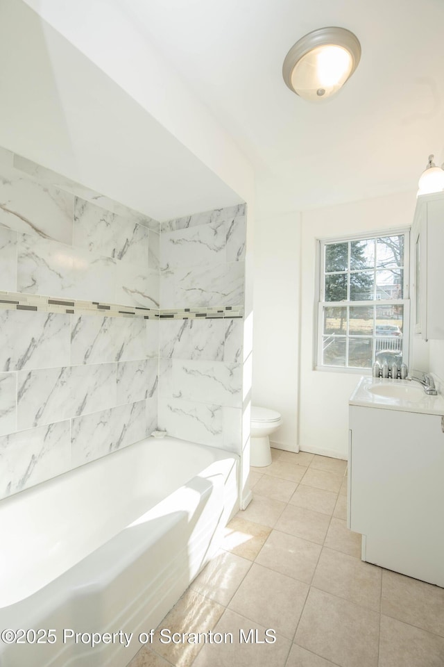 full bathroom featuring vanity, a bathtub, toilet, and tile patterned floors