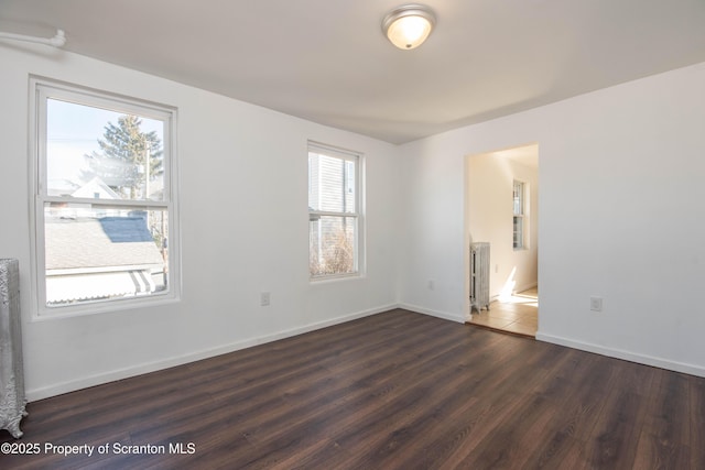 interior space with wood finished floors and baseboards