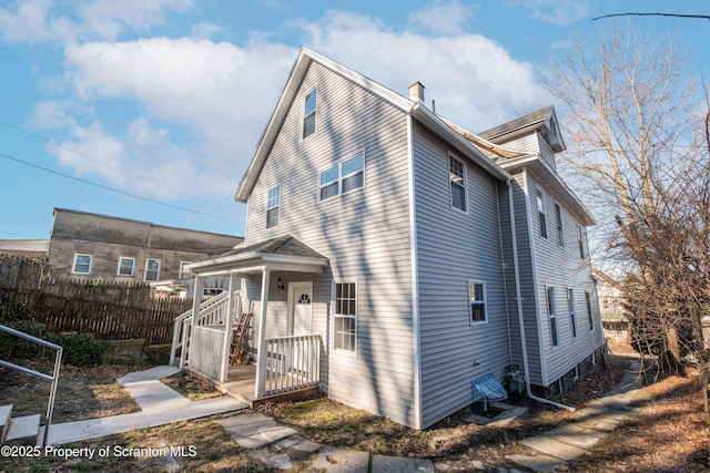 view of front of property featuring fence