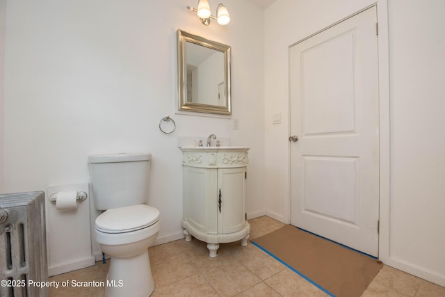 bathroom featuring tile patterned flooring, radiator, baseboards, and toilet