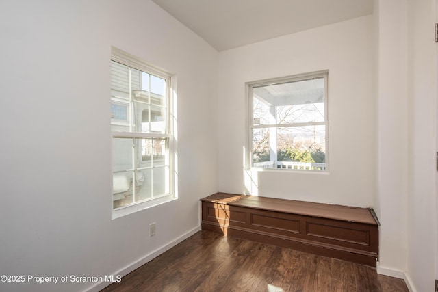 empty room featuring dark wood-type flooring and baseboards