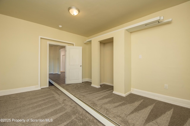 empty room with carpet floors and baseboards