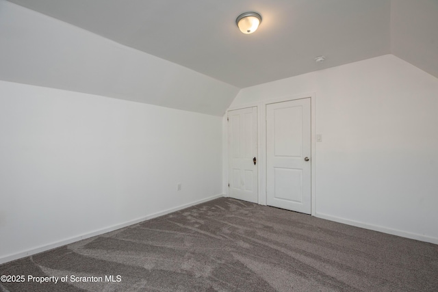 bonus room with lofted ceiling, baseboards, and carpet flooring