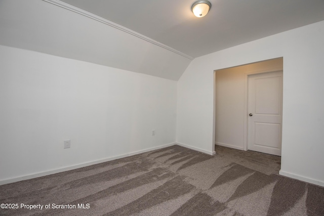 additional living space featuring lofted ceiling, carpet, and baseboards